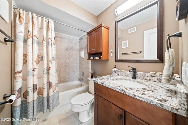 a plant sitting in front of a house with potted plants