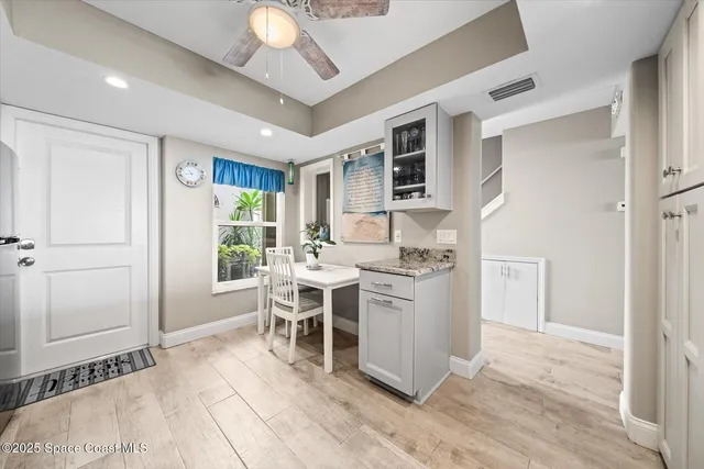 a view of a kitchen with a dining table and chairs