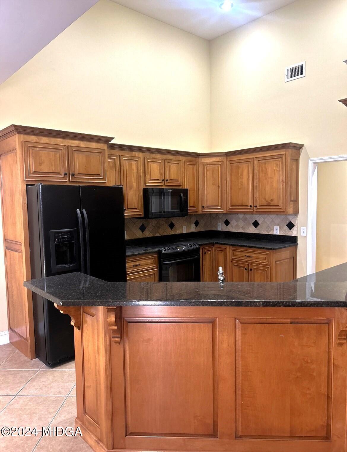 208 Pembroke Centerville, GA 31028 - Photo 4 of 30 a kitchen with stainless steel appliances granite countertop a stove a sink and a microwave