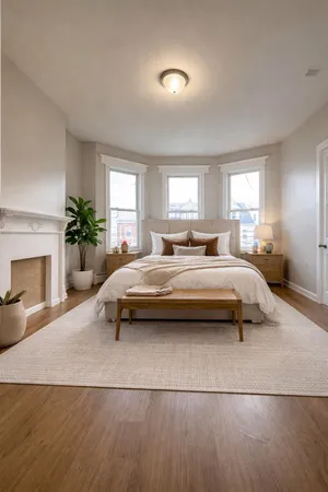 a bedroom with a bed and a fireplace