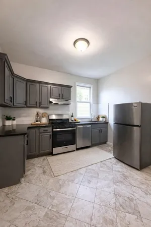 a kitchen with stainless steel appliances a refrigerator sink and cabinets