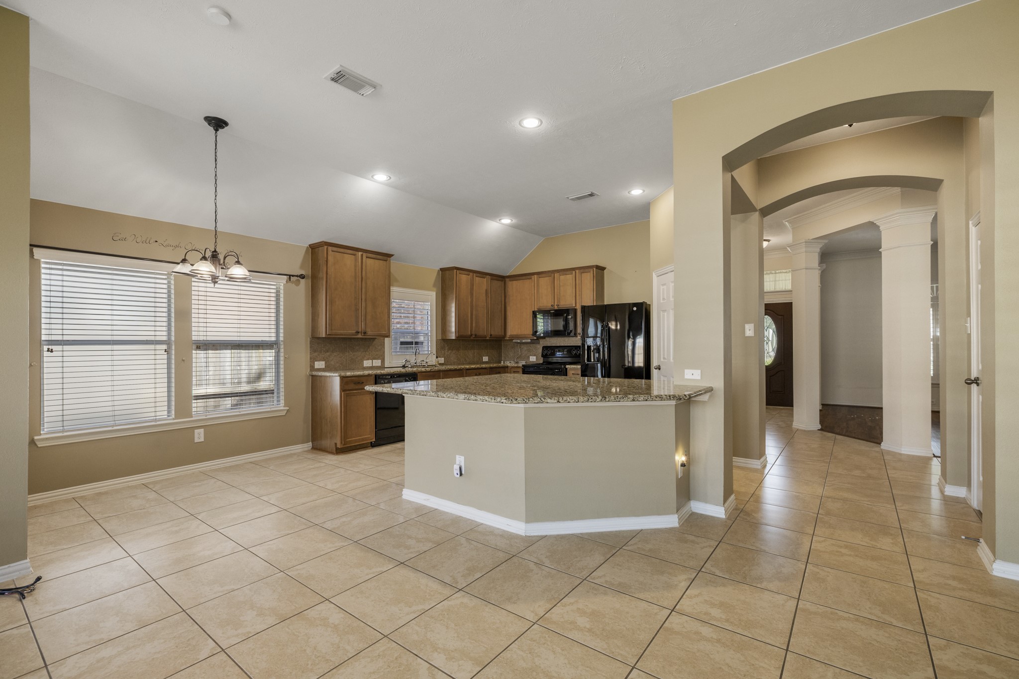 20014 Queens Oak Court Spring, TX 77379 - Photo 11 of 49 a kitchen with stainless steel appliances kitchen island granite countertop a refrigerator and a sink