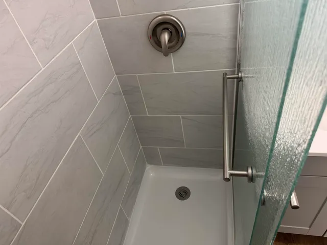 a bathroom with a shower and a sink