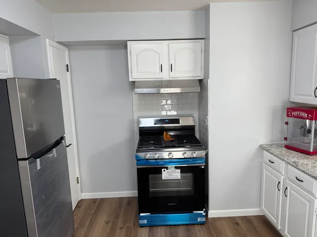 a kitchen with stainless steel appliances a stove and a refrigerator