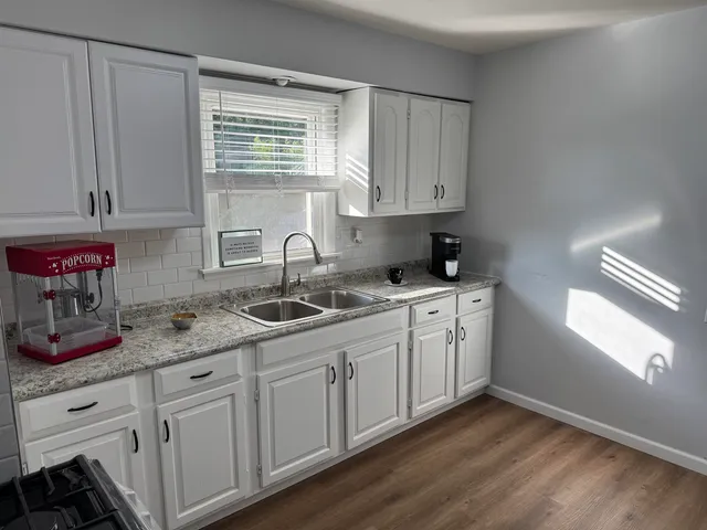 a kitchen with sink cabinets and window