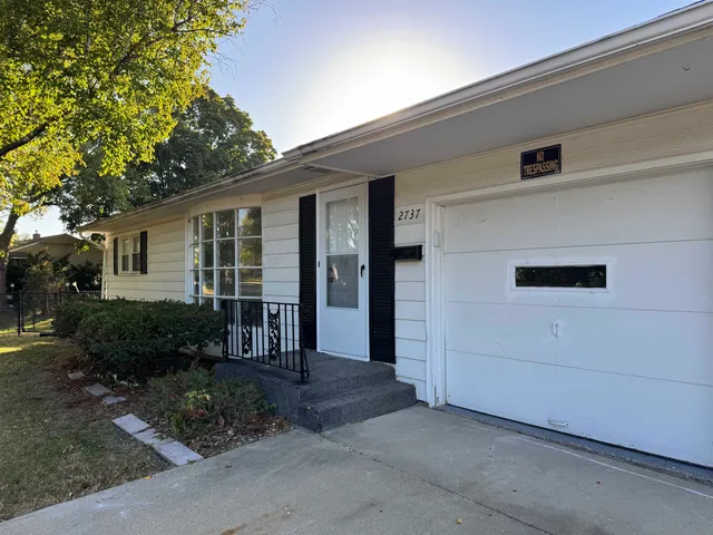 a backyard of a house with plants and tree