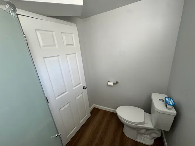 a white toilet sitting next to a sink