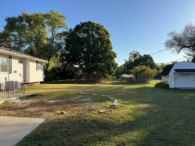 a swimming pool with outdoor seating and yard