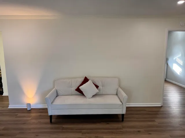 a living room with furniture and wooden floor