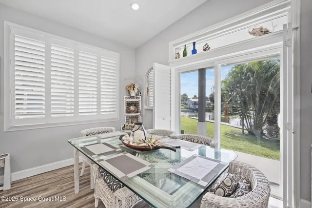a dining room with furniture a window and wooden floor
