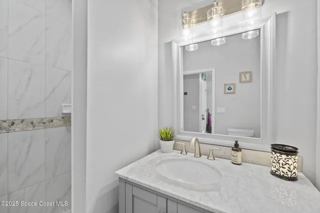 a bathroom with a shower and a sink