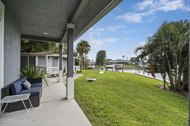 a view of a porch with furniture and a fireplace