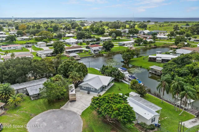 an aerial view of a house with a yard