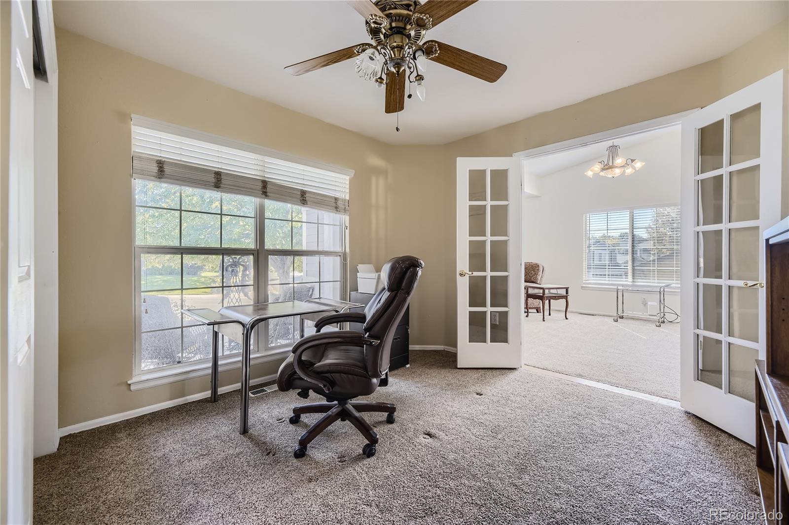2145 Fox Fire Street Highlands Ranch, CO 80129 - Photo 9 of 29 a view of a workspace with furniture and a window