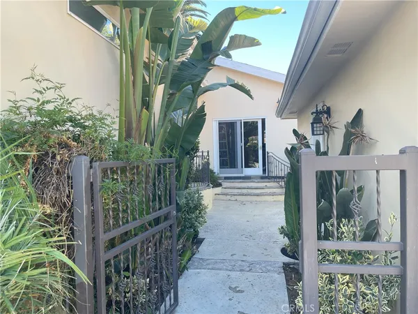 a view of a house with entrance and plants