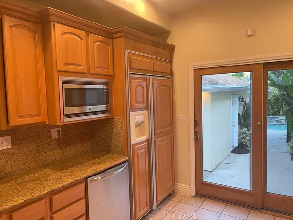a kitchen with stainless steel appliances granite countertop a refrigerator and a sink