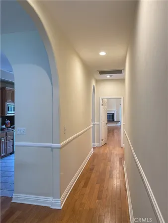 a view of a hallway view with wooden floor and staircase