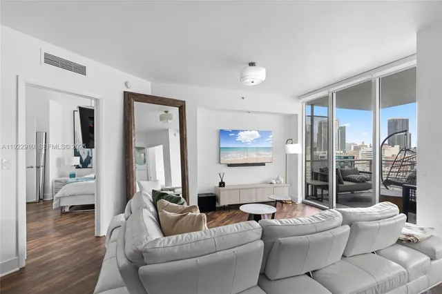 a living room with furniture and a chandelier
