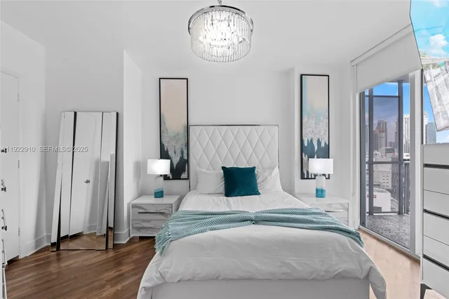 a bedroom with a bed and a chandelier