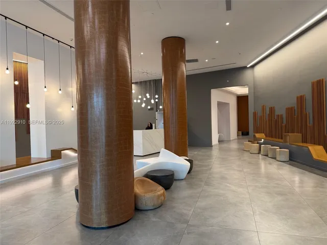 a view of hallway with a bathroom and a window