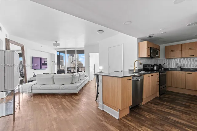a living room with furniture and a wooden floor