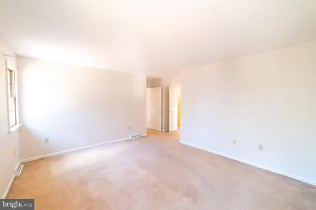 a spacious bathroom with a granite countertop toilet sink and mirror