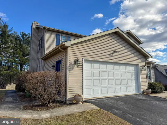 an aerial view of a house with a yard and lake view