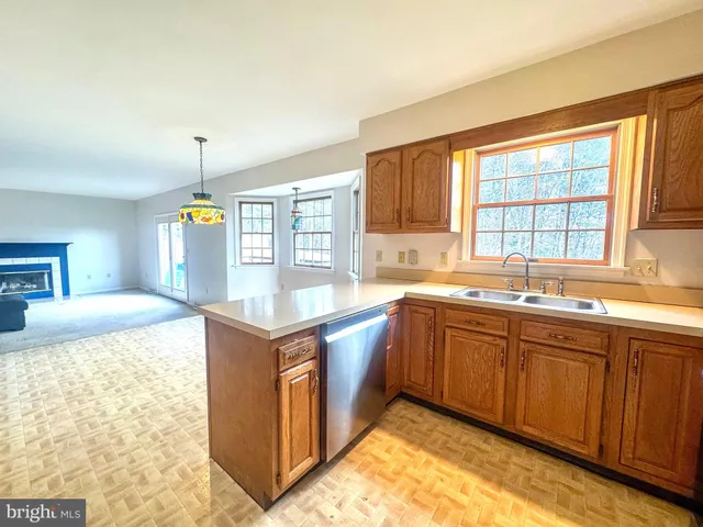 a kitchen with stainless steel appliances granite countertop a sink and a stove