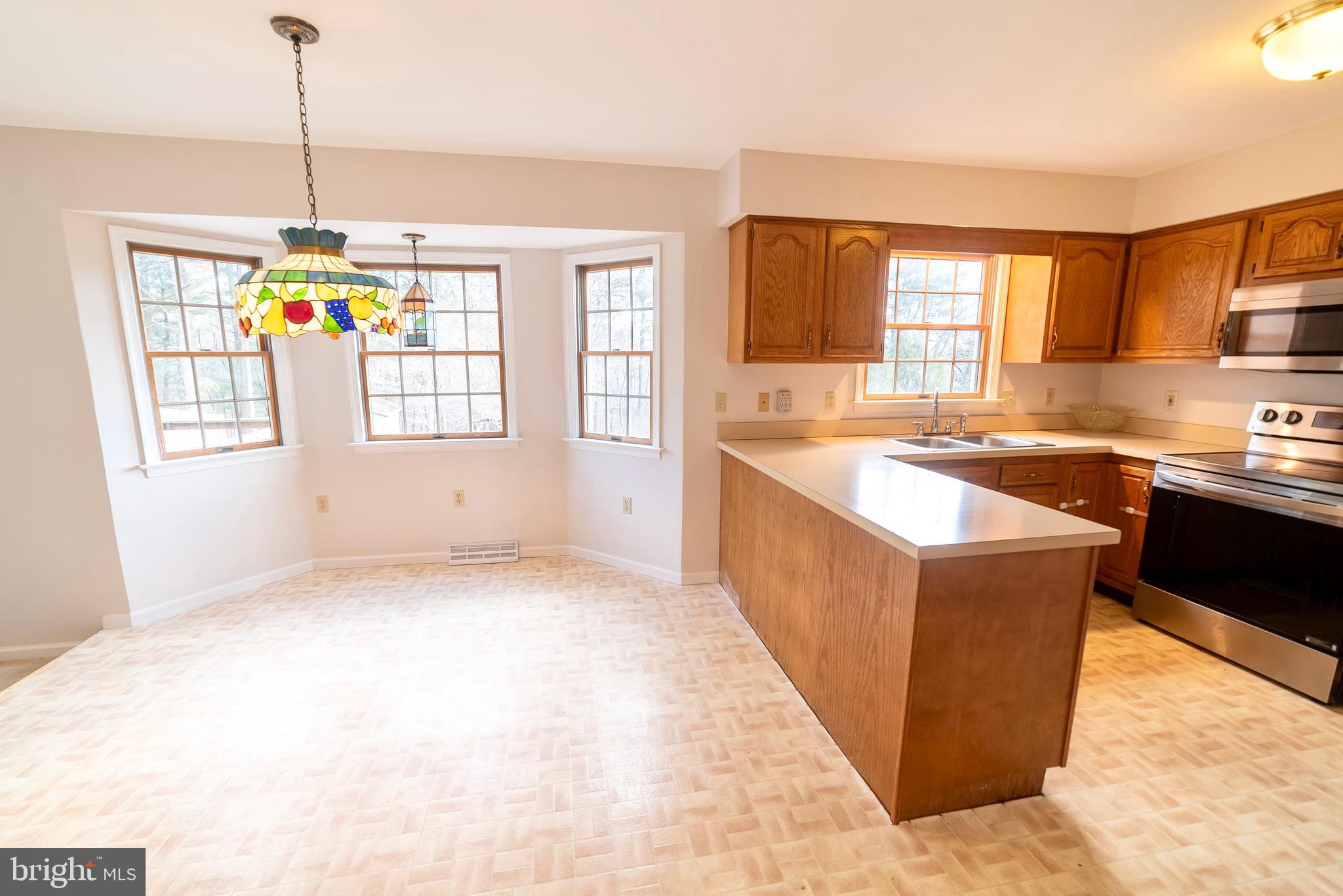 619 Stoney Run Road Pottsville, PA 17901 - Photo 8 of 41 a kitchen with stainless steel appliances granite countertop a sink stove and refrigerator