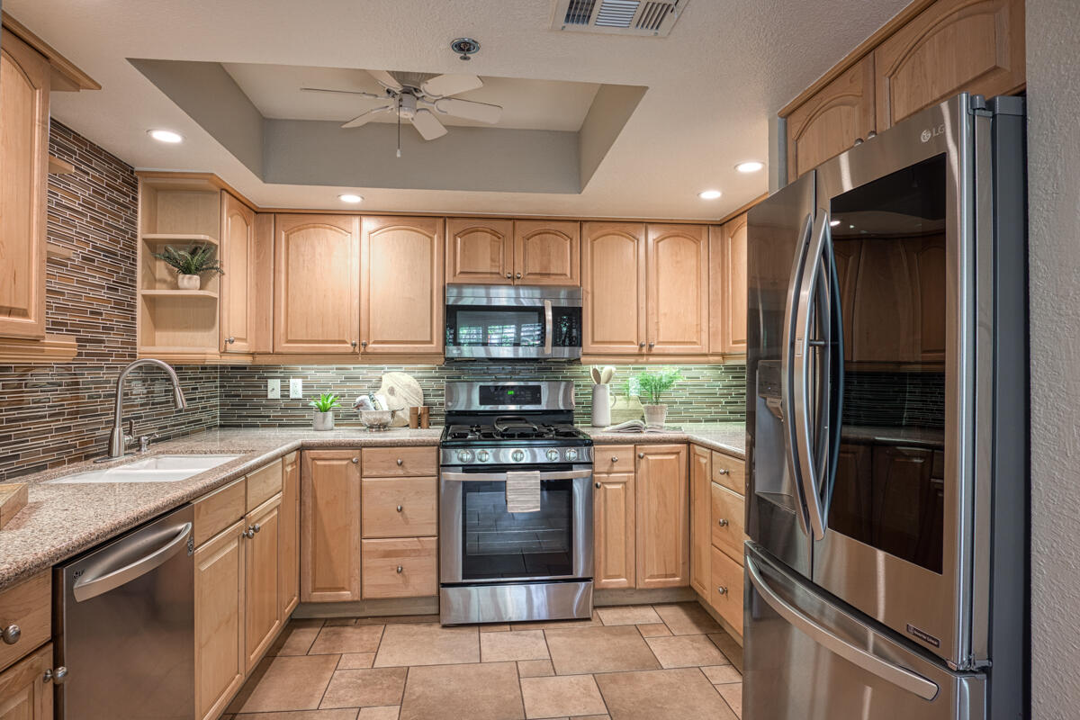 200 East Racquet Club Road, Unit 65 Palm Springs, CA 92262 - Photo 3 of 27 a kitchen with a sink stove and refrigerator