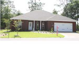 4630 Hermosa Road Crestview, FL 32539 - Photo 3 of 29 a view of a house with a garden and yard