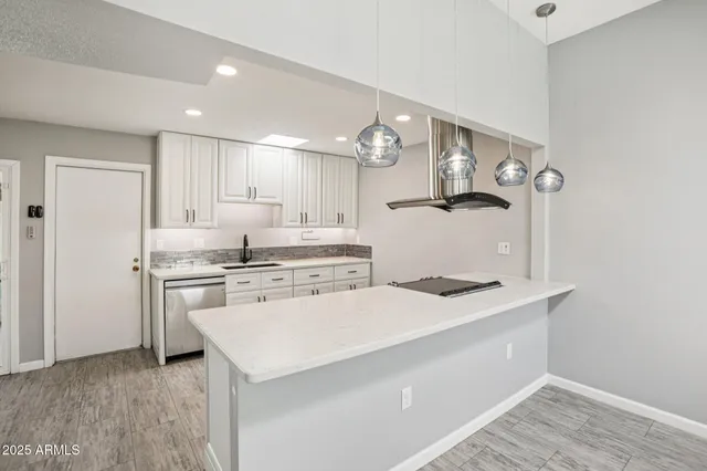 a kitchen that has a sink and a stove in it