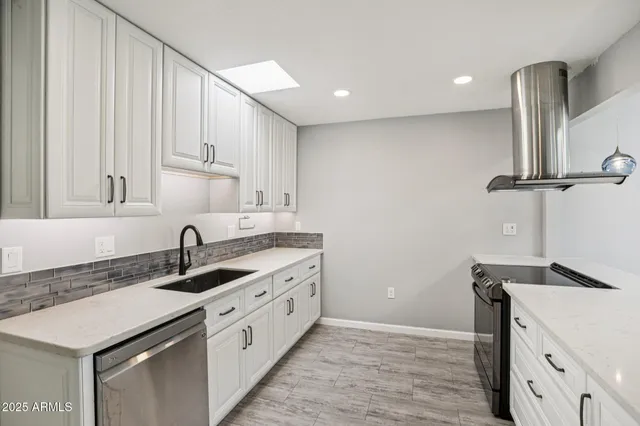 a kitchen with granite countertop a stove and a sink