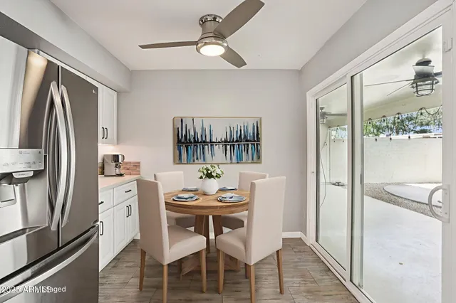 a view of a kitchen with a refrigerator and a stove top oven