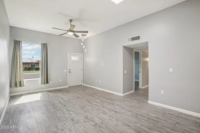 wooden floor in an empty room with a window