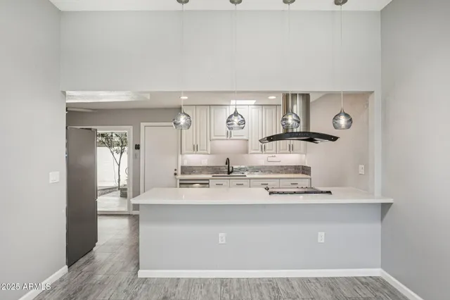 a kitchen with a stove a sink and a refrigerator