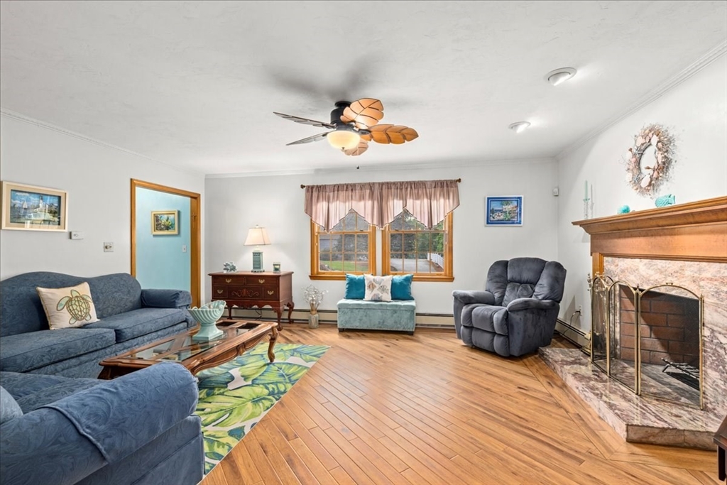 27 Crestview Drive Uxbridge, MA 01569 - Photo 12 of 39 a living room with furniture fireplace and a large window