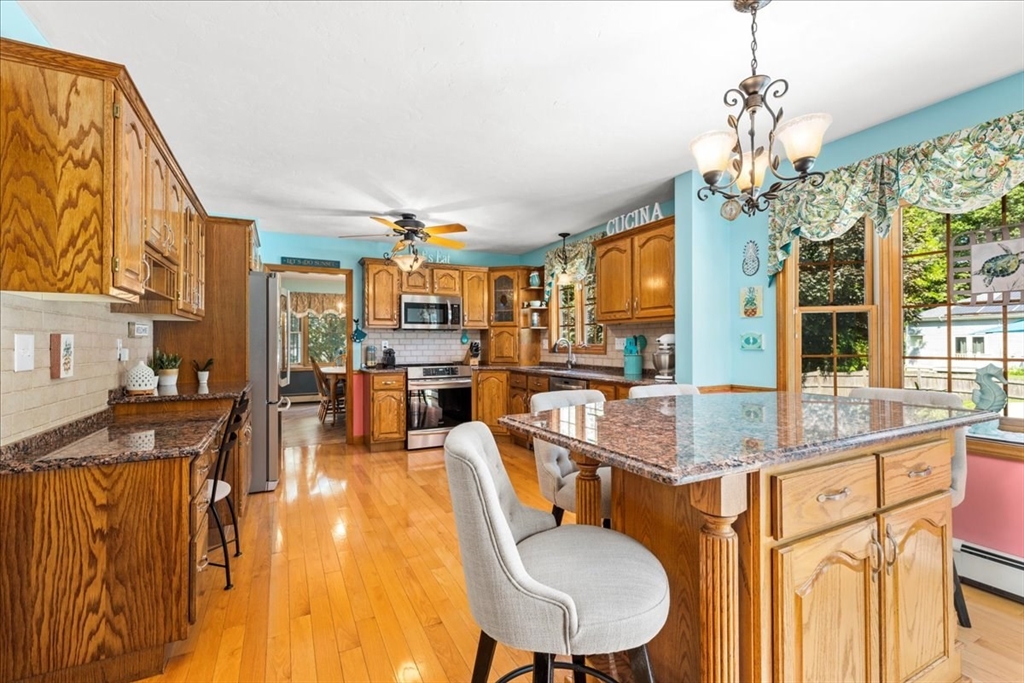 27 Crestview Drive Uxbridge, MA 01569 - Photo 2 of 39 a dining room with furniture a chandelier and wooden floor