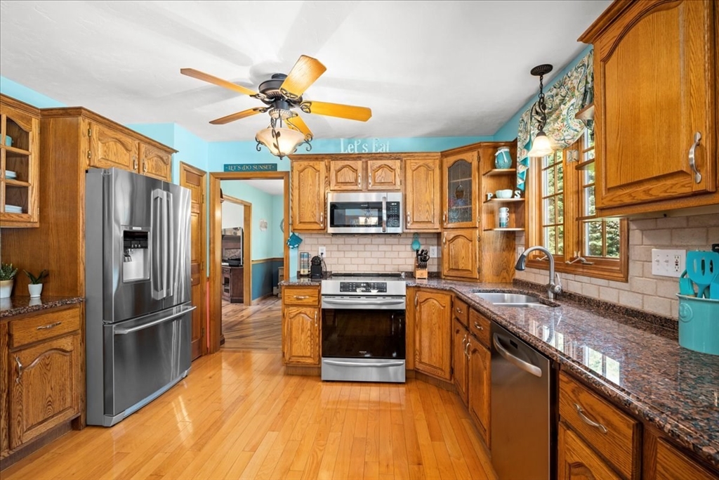27 Crestview Drive Uxbridge, MA 01569 - Photo 3 of 39 a kitchen with stainless steel appliances granite countertop a refrigerator a stove and a sink
