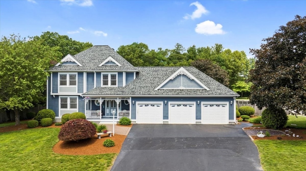 27 Crestview Drive Uxbridge, MA 01569 - Photo 39 of 39 a front view of a house with a garden and plants