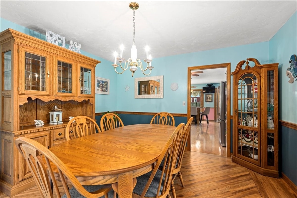 27 Crestview Drive Uxbridge, MA 01569 - Photo 8 of 39 a dining room with furniture a chandelier and wooden floor