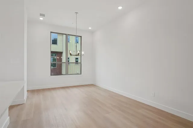a view of an empty room with glass door