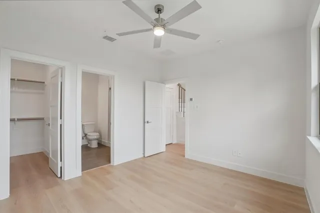 a view of staircase with railing and white walls
