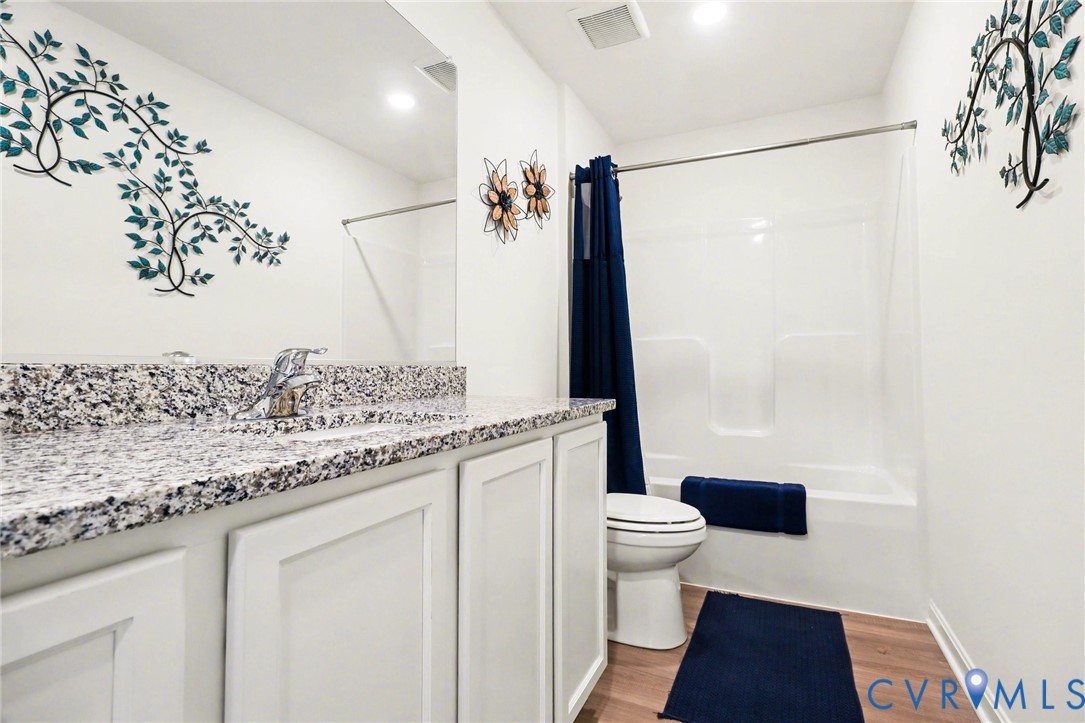 17075 Rollins Road Bowling Green, VA 22427 - Photo 14 of 16 a bathroom with a granite countertop sink toilet and shower
