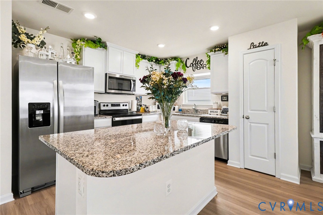 17075 Rollins Road Bowling Green, VA 22427 - Photo 9 of 23 a kitchen with stainless steel appliances granite countertop a refrigerator a stove and a sink