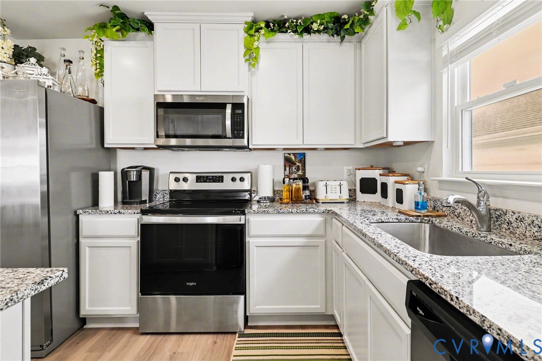 17075 Rollins Road Bowling Green, VA 22427 - Photo 10 of 23 a kitchen with a sink stove and microwave