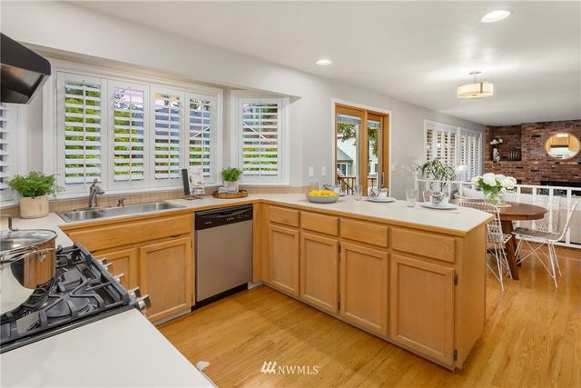 a kitchen with stainless steel appliances granite countertop a sink stove and cabinets