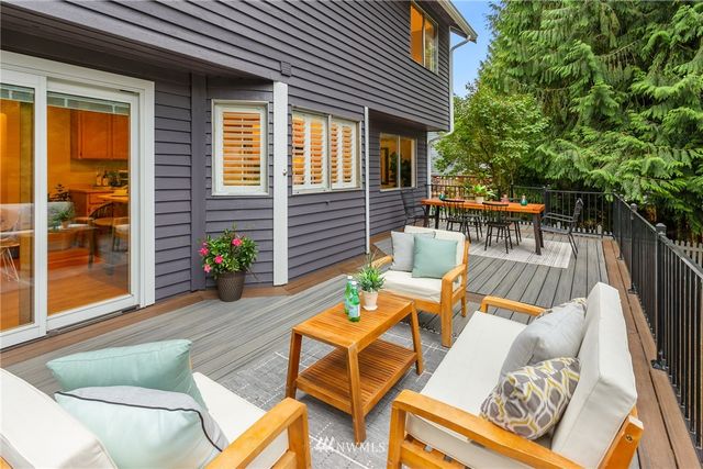 a view of a patio with couches chairs and a potted plant