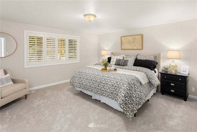 a bedroom with a bed and a couch