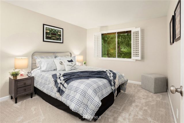 a bedroom with bed and a window